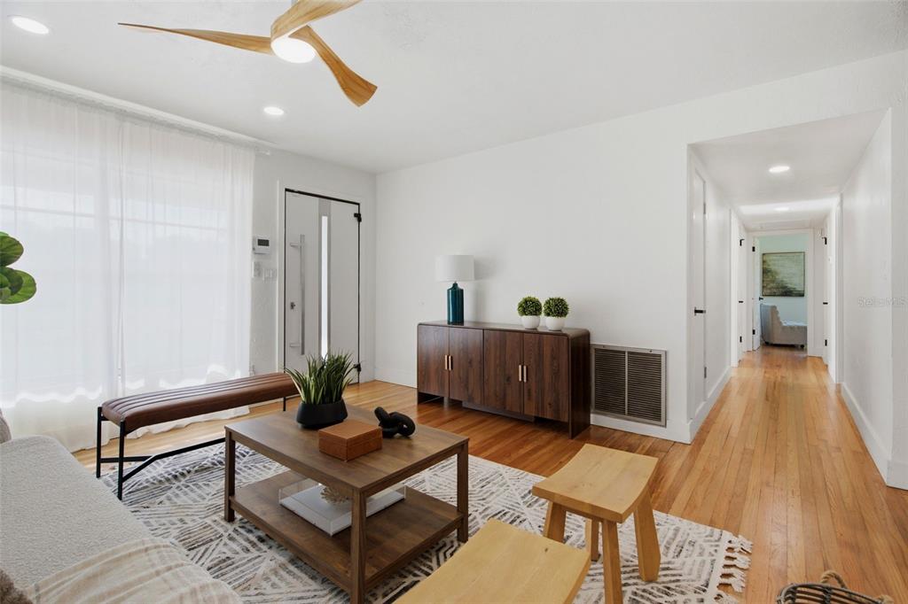 A living room features hardwood floors, a wooden ceiling fan, and a dark wood console — 832 THALIA DRIVE, ORLANDO, FL
