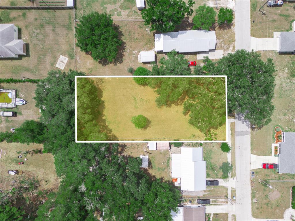 A large, grassy yard with mature trees and a house visible in the background — 0 S PERRY AVENUE, FORT MEADE, FL