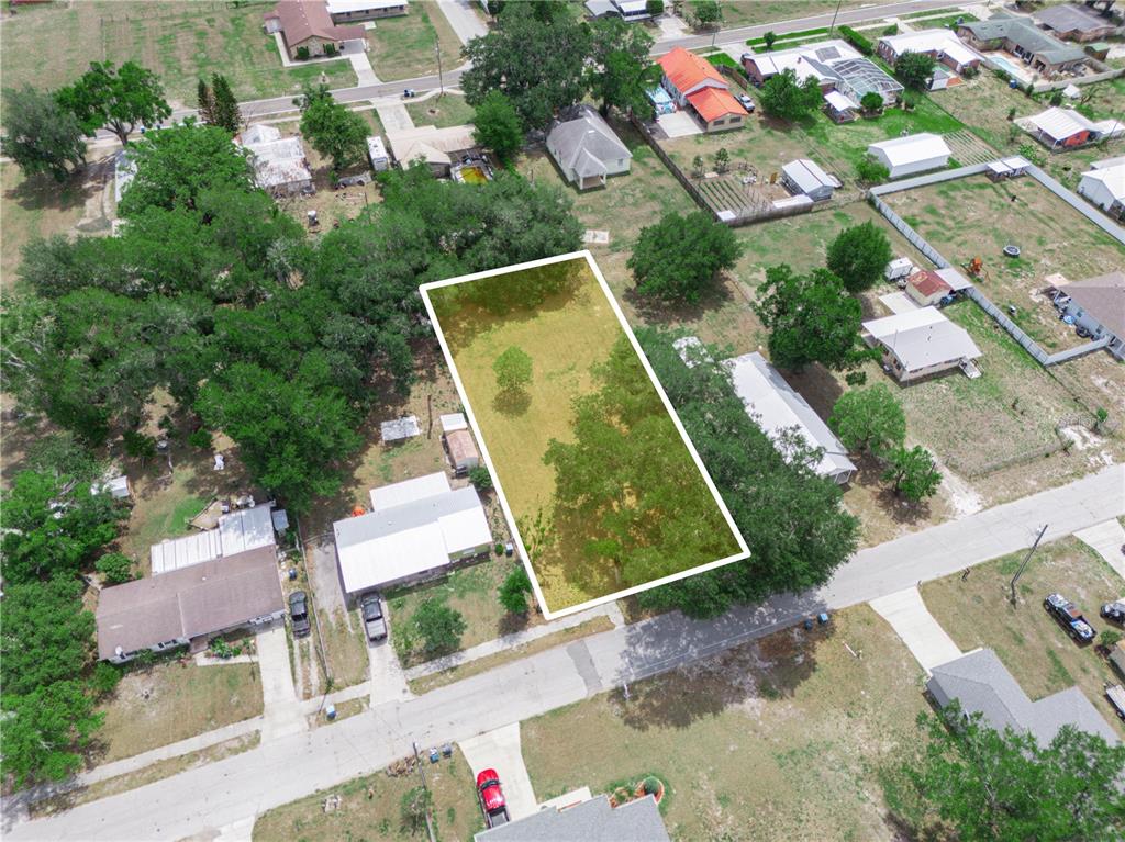 An aerial view shows a rectangular vacant lot surrounded by trees and residential properties — 0 S PERRY AVENUE, FORT MEADE, FL