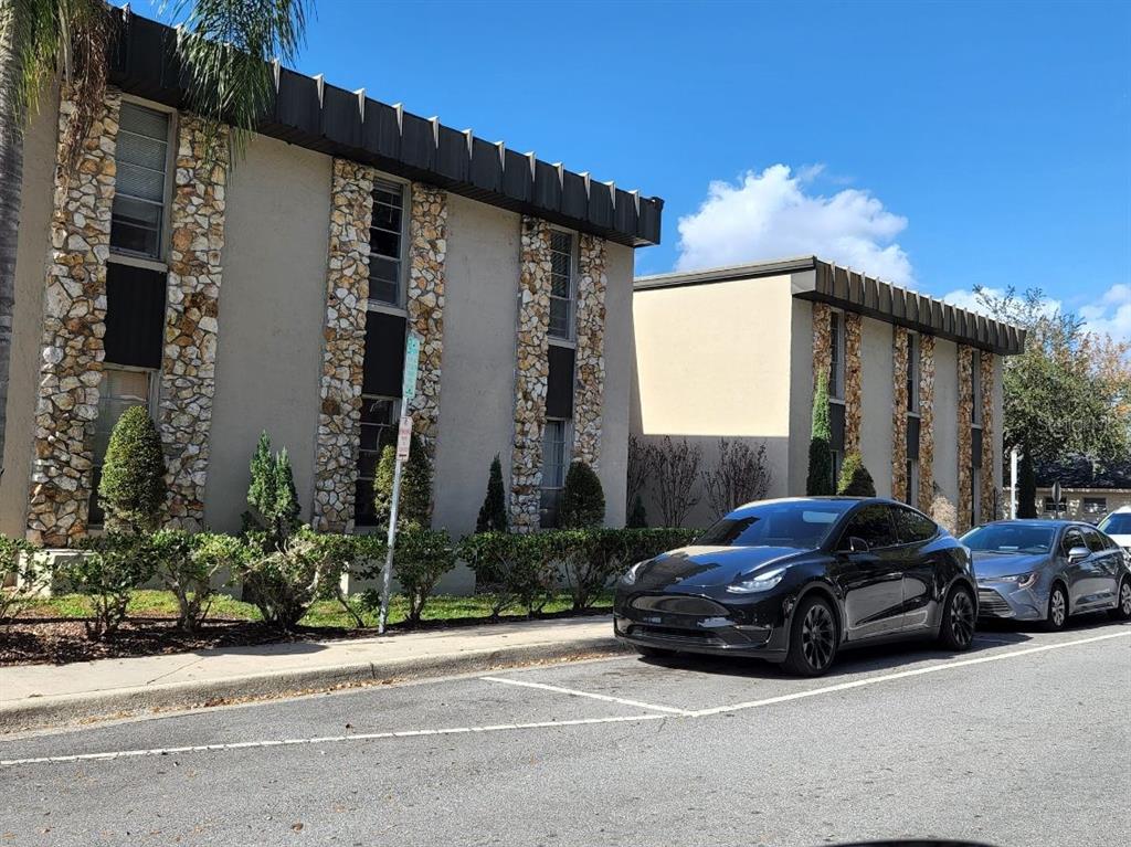 A two-story apartment building with stone accents and a parking lot in front — 20 S ROSE AVENUE, KISSIMMEE, FL
