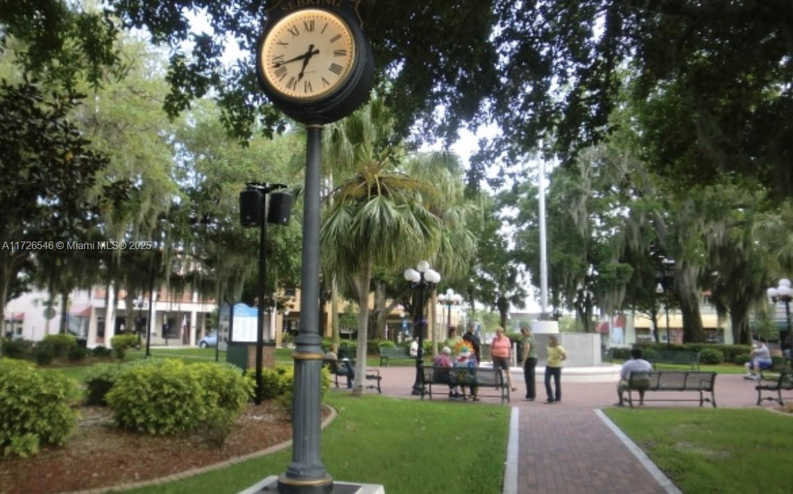 A street clock stands in a public park with brick walkways, benches, and mature trees — 6451 San Bruno Drive, Sebring FL 33872, SEBRING, FL