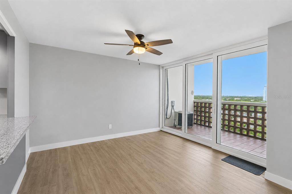 A room with light wood flooring, a ceiling fan, and sliding glass doors to a balcony — 4015 BAYSHORE BOULEVARD UNIT 12B, TAMPA, FL
