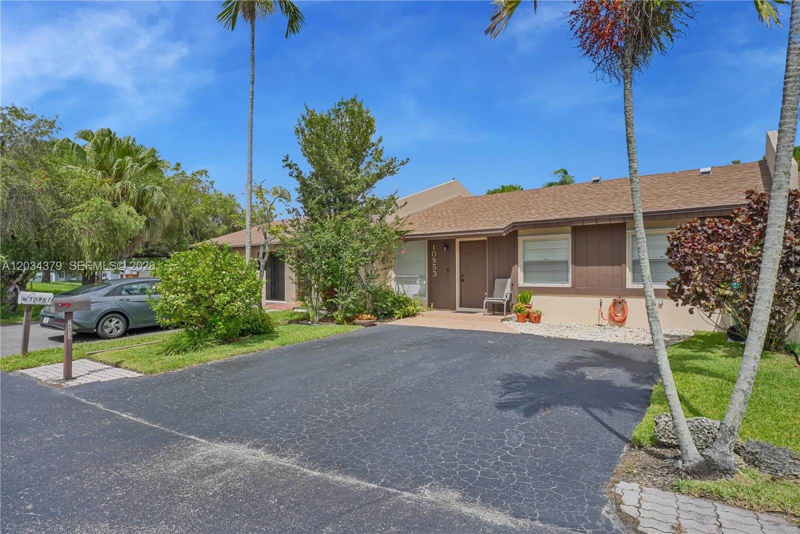 A single-story house with a brown roof, tan siding, and a paved driveway — 10953 SW 122nd Ct, Miami FL 33186, MIAMI, FL