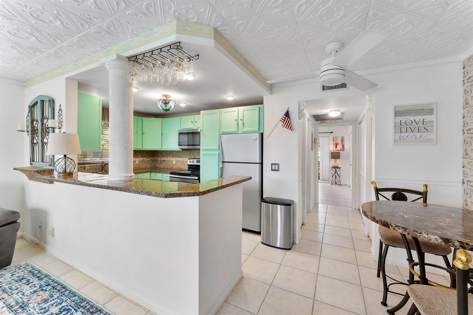 A kitchen with mint green cabinets, a granite breakfast bar, and a white ceiling — 269 S Ventnor S # 269, Deerfield Beach FL 33442, DEERFIELD BEACH, FL