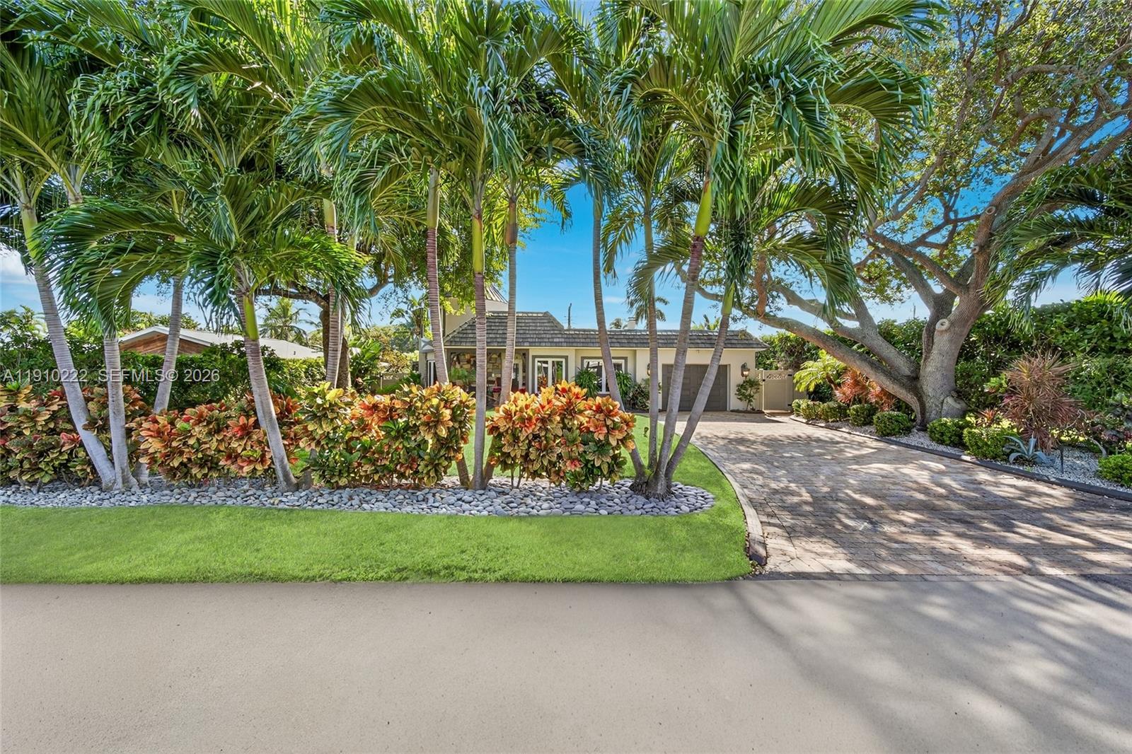 A single-story house with a stone-accented turret, a covered porch, and a tiled roof — 3414 Norfolk St, Pompano Beach FL 33062, POMPANO BEACH, FL