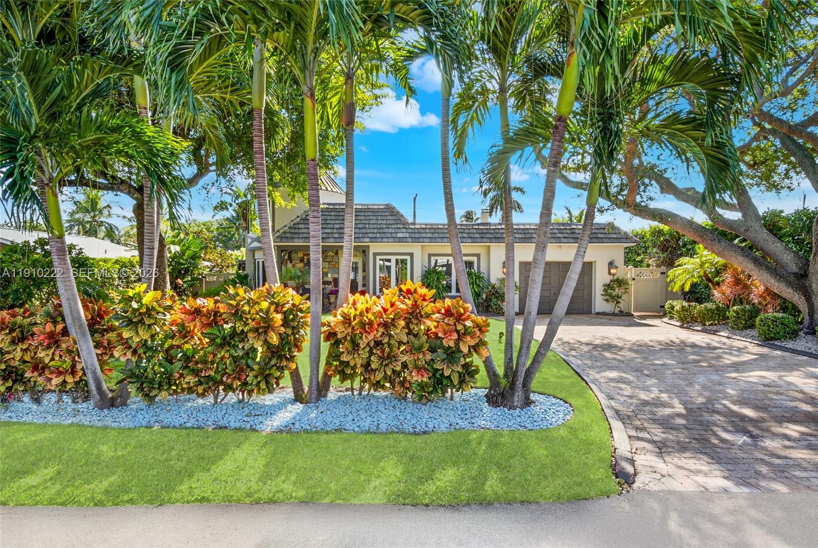 A single-story house features a stone-accented entrance, a turret, and a paved driveway — 3414 Norfolk St, Pompano Beach FL 33062, POMPANO BEACH, FL