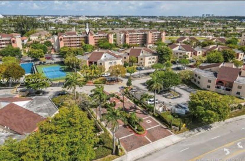 An aerial view of a multi-story apartment complex with a tennis court and parking lot — 10253 NW 9th Street Cir # 6, Miami FL 33172, MIAMI, FL