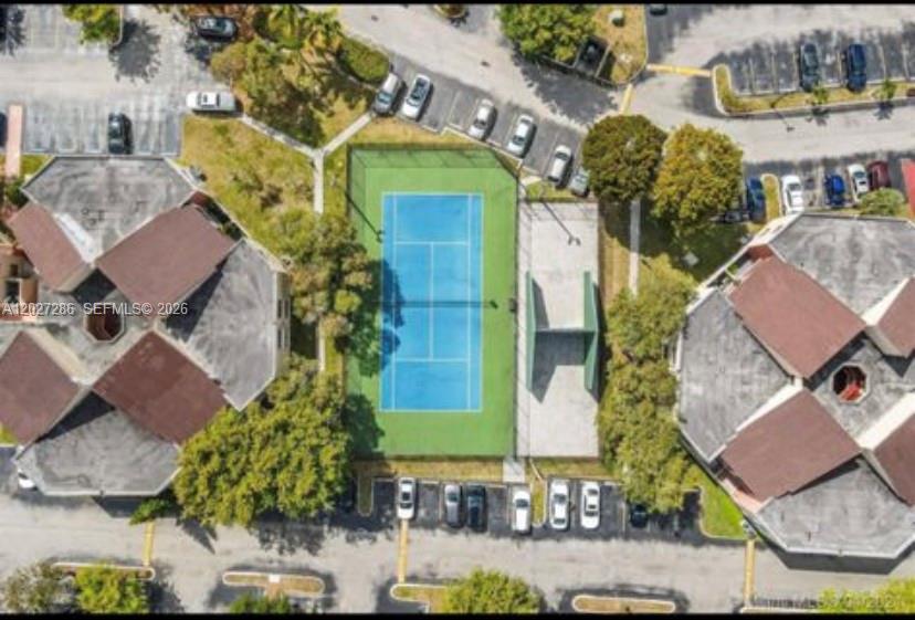 An aerial view shows a blue tennis court situated between two multi-story residential buildings — 10253 NW 9th Street Cir # 6, Miami FL 33172, MIAMI, FL
