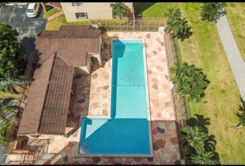 An aerial view shows an L-shaped swimming pool with a stone deck and adjacent building — 10253 NW 9th Street Cir # 6, Miami FL 33172, MIAMI, FL