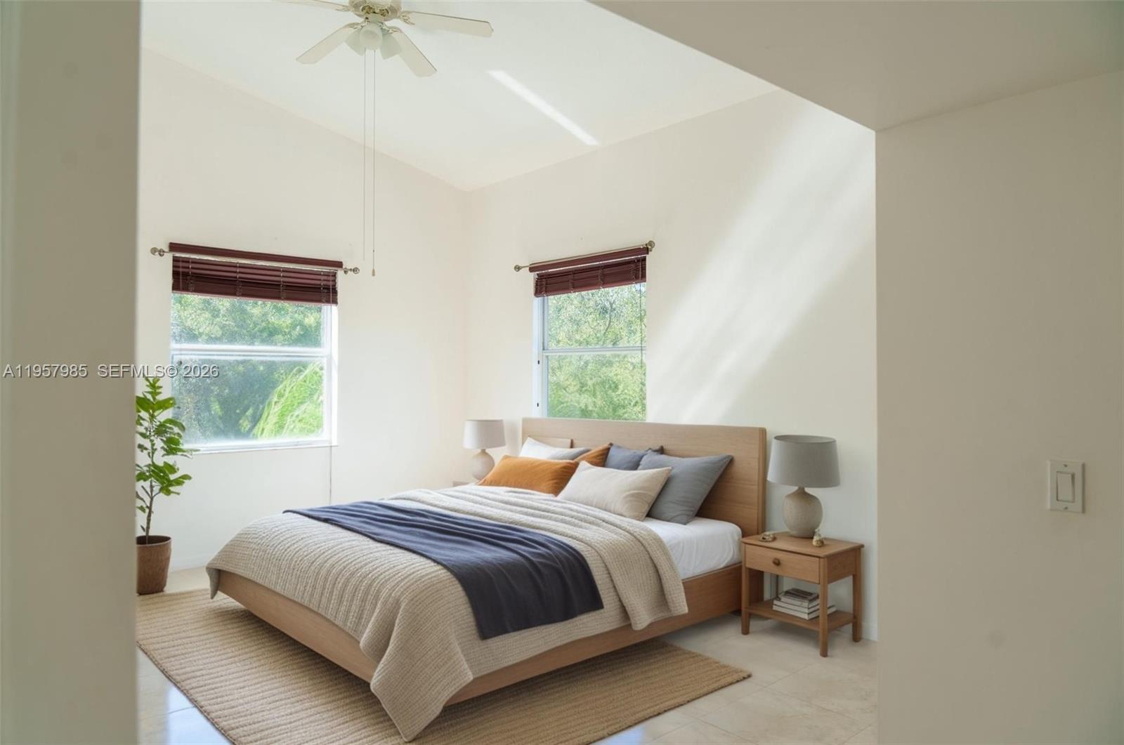 A bedroom features a wooden bed frame, two windows with blinds, and a ceiling fan — 509 E Sheridan St # 3083, Dania Beach FL 33004, DANIA BEACH, FL