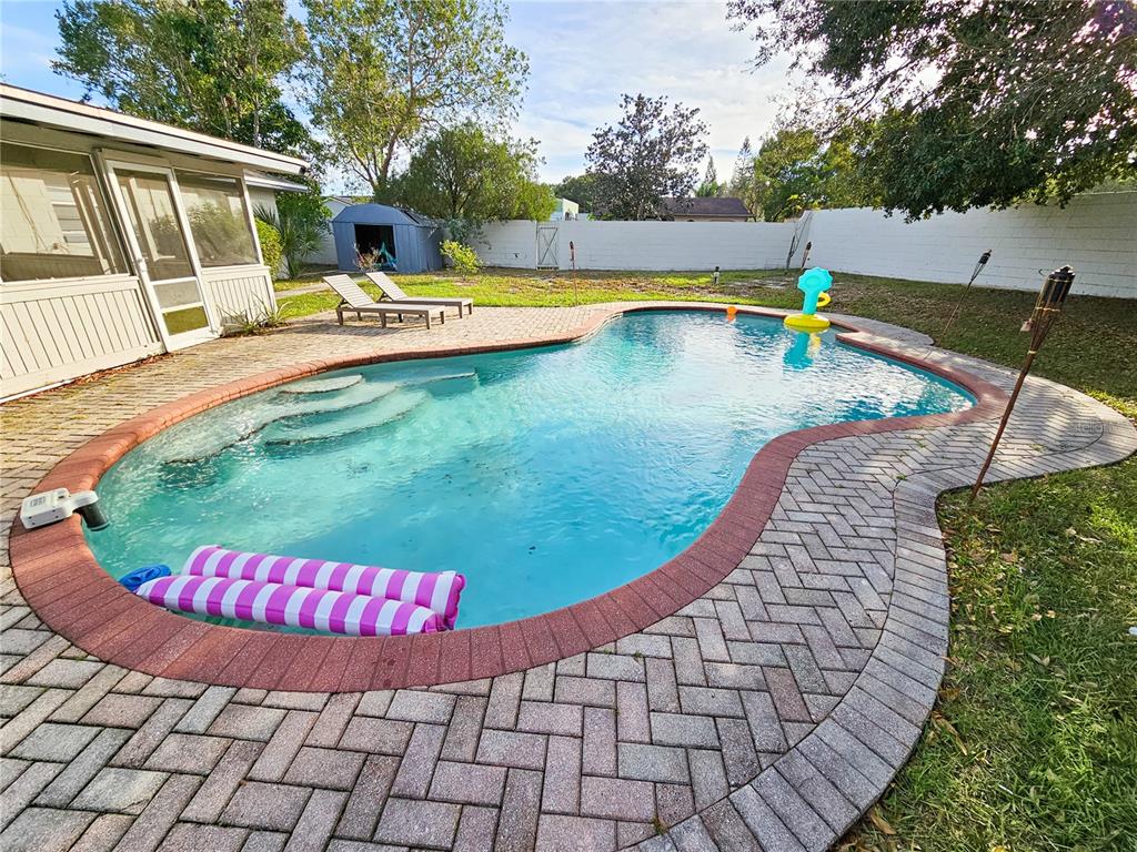 A backyard features an inground swimming pool with a brick paver deck and lounge chairs — 212 S CORTEZ AVENUE, WINTER SPRINGS, FL