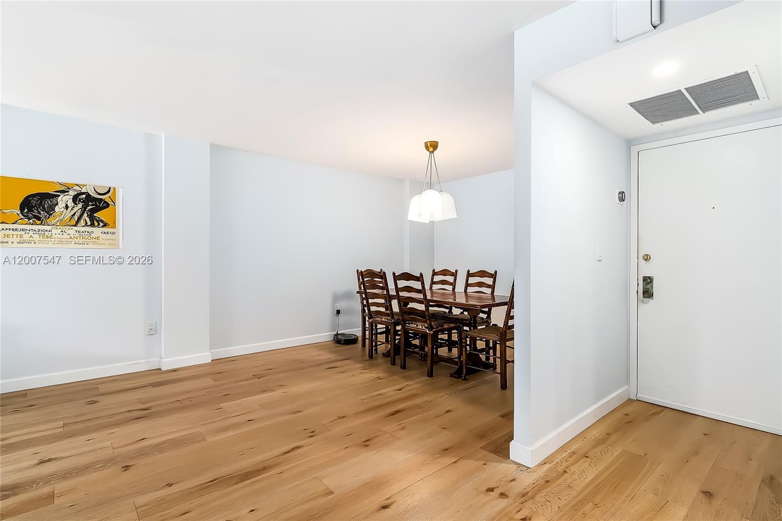 A dining area with a wooden table and chairs sits on light hardwood floors — 2808 N 46th Ave # E549, Hollywood FL 33021, HOLLYWOOD, FL