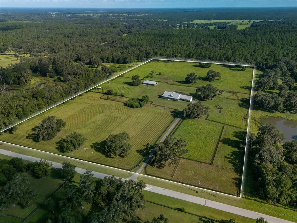 An aerial view shows a large rural property with a house, barn, and fenced pastures — 13211 NW 115TH STREET, OCALA, FL