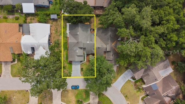 An aerial view shows a single-family home with a gray roof and driveway — 1033 OLD SOUTH LANE, APOPKA, FL