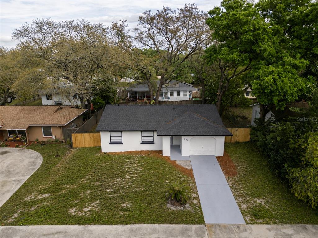 An aerial view of a white single-story house with a dark roof and driveway — 821 OSCEOLA TRAIL, CASSELBERRY, FL