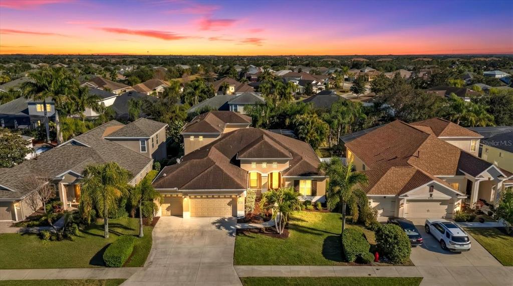 An aerial view shows a suburban house with a brown roof and a concrete driveway — 4727 BALBOA PARK LOOP, BRADENTON, FL