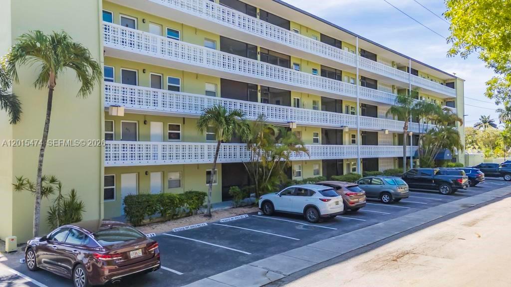 A multi-story apartment building with exterior walkways and a parking lot in front — 1425 Arthur St # 103A, Hollywood FL 33020, HOLLYWOOD, FL