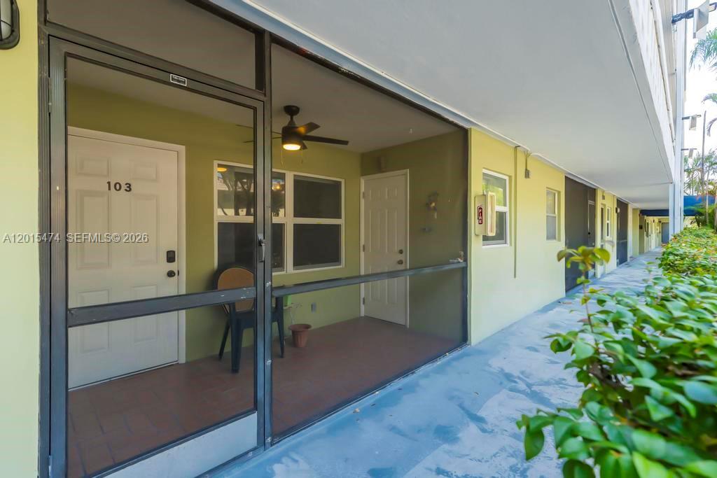 A ground-level apartment entrance features a screened-in porch with a ceiling fan and door 103 — 1425 Arthur St # 103A, Hollywood FL 33020, HOLLYWOOD, FL