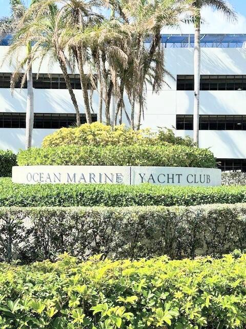 A sign for Ocean Marine Yacht Club sits in front of a building and landscaping — 1945 S Ocean Drive # 701, Hallandale Beach FL 33009, HALLANDALE BEACH, FL