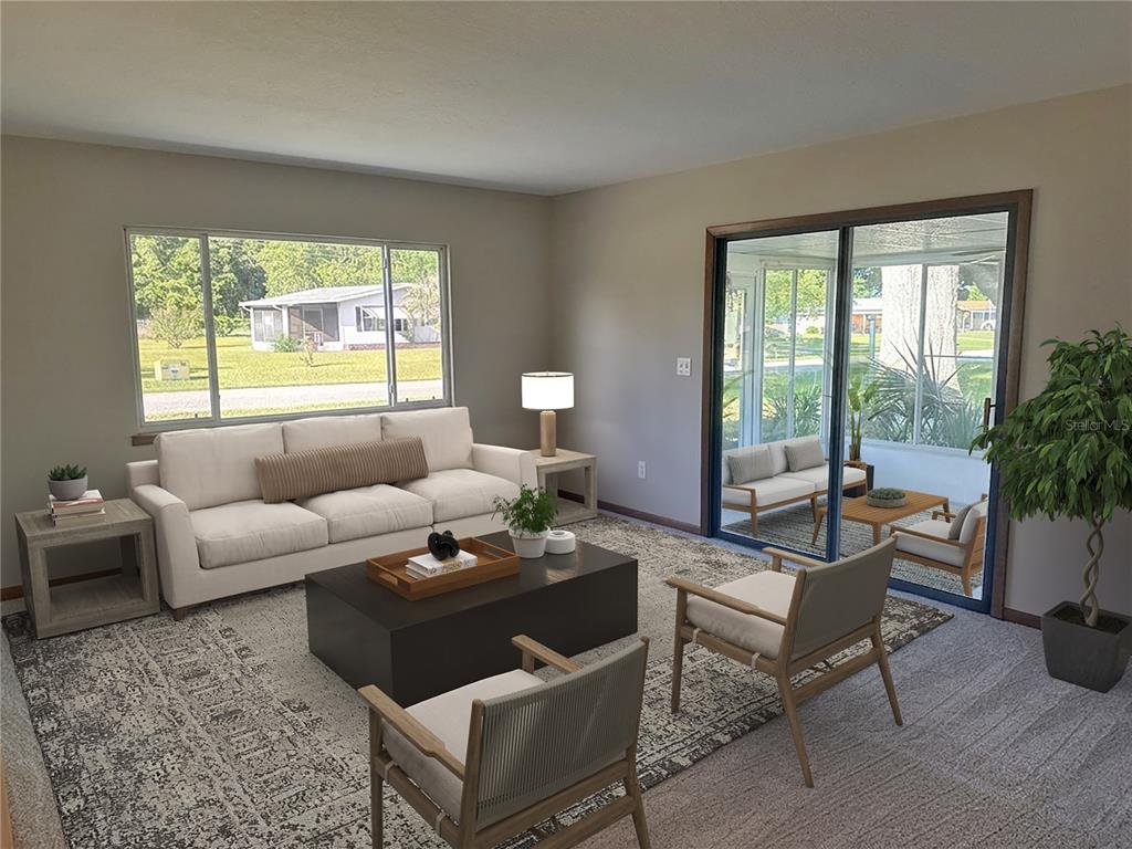 A living room with a sofa, two armchairs, a coffee table, and a glass sliding door — 9095 SW 104TH LANE, OCALA, FL