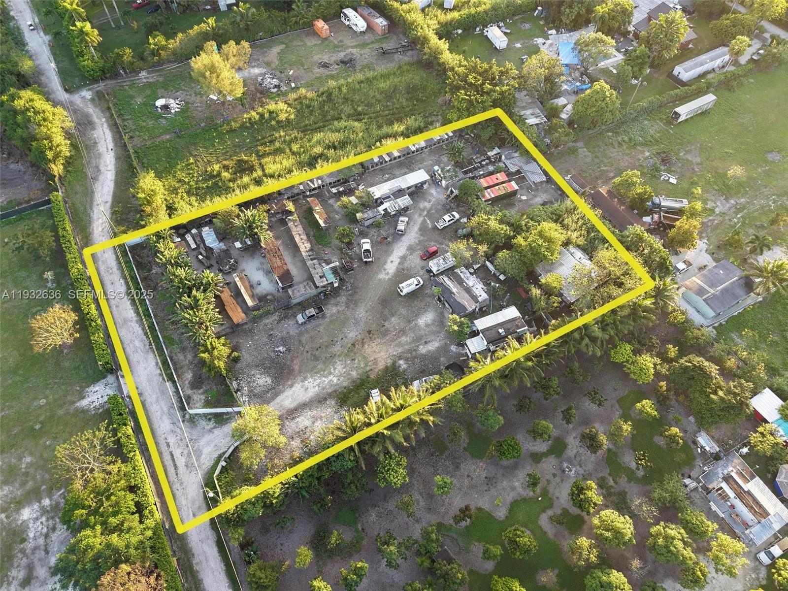 An aerial view shows a rectangular lot containing multiple structures, vehicles, and trees — 15400 SW 207th ave, Miami FL 33187, MIAMI, FL