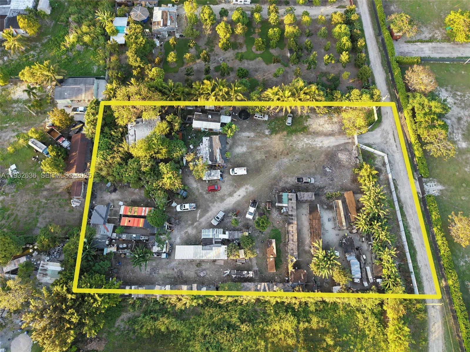 An aerial view shows a large, rectangular lot with multiple structures, vehicles, and scattered trees — 15400 SW 207th ave, Miami FL 33187, MIAMI, FL