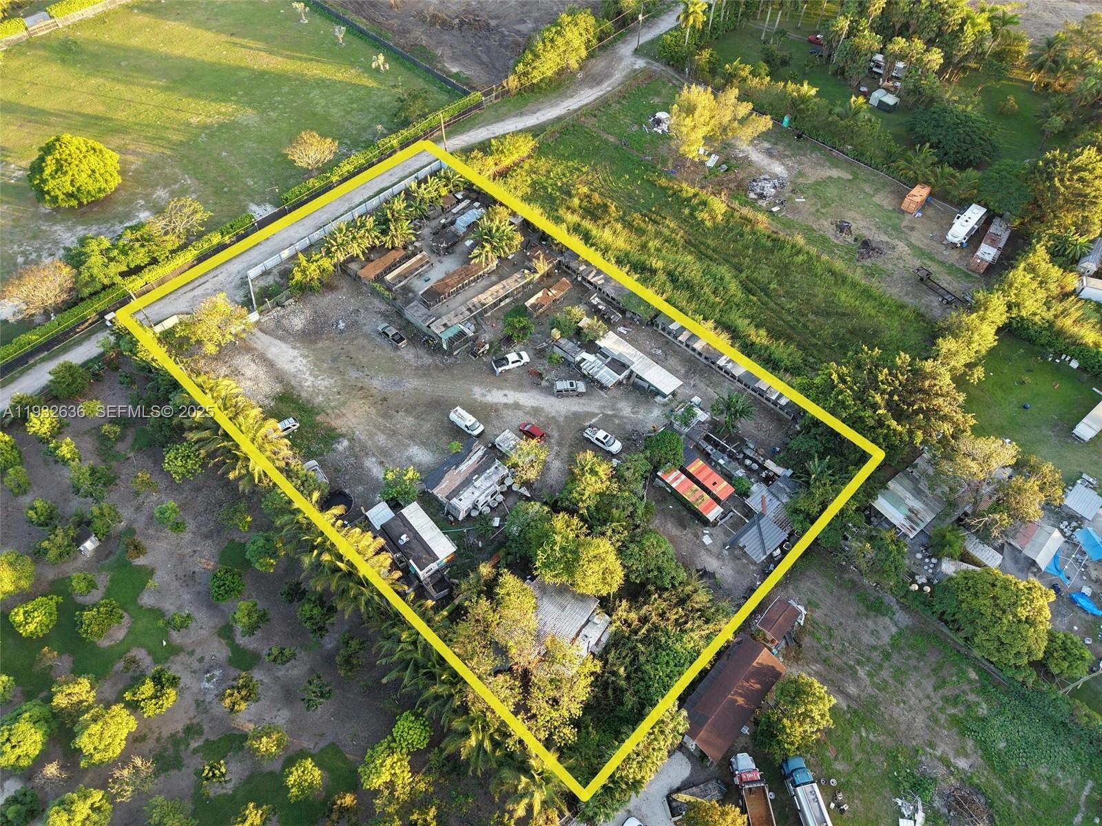 An aerial view shows a rectangular property lot containing several small structures and vehicles — 15400 SW 207th ave, Miami FL 33187, MIAMI, FL