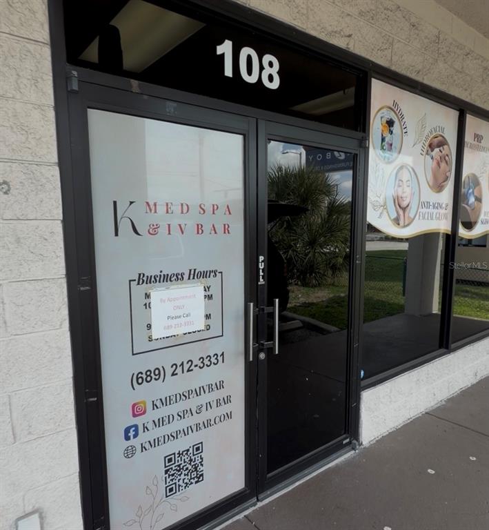 The exterior entrance of a commercial med spa unit features glass doors and signage — 11601 S ORANGE BLOSSOM TRAIL UNIT 108, ORLANDO, FL