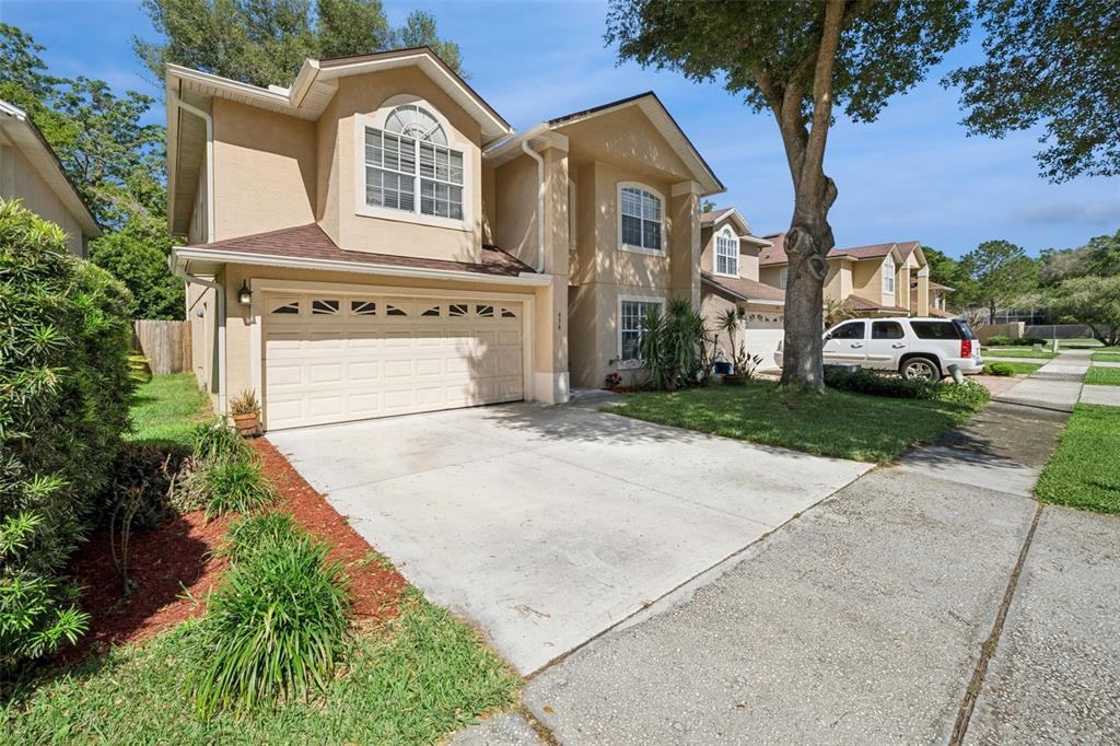 A two-story tan house with a two-car garage and a concrete driveway — 436 OPAL COURT, ALTAMONTE SPRINGS, FL