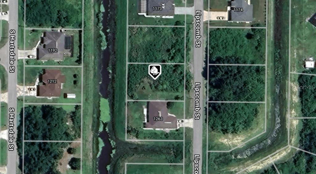This is an aerial map view showing residential lots and a canal — Lot 8 S LIPSCOMB STREET, NORTH PORT, FL