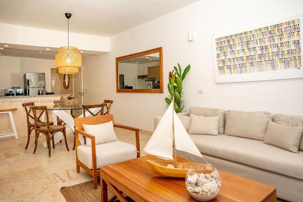 A living and dining area features a beige sofa, wooden coffee table, and wicker pendant light — 0000 8C3F+Q62, Las Terrenas 32000, Dominican Republic # 1, DR, DR