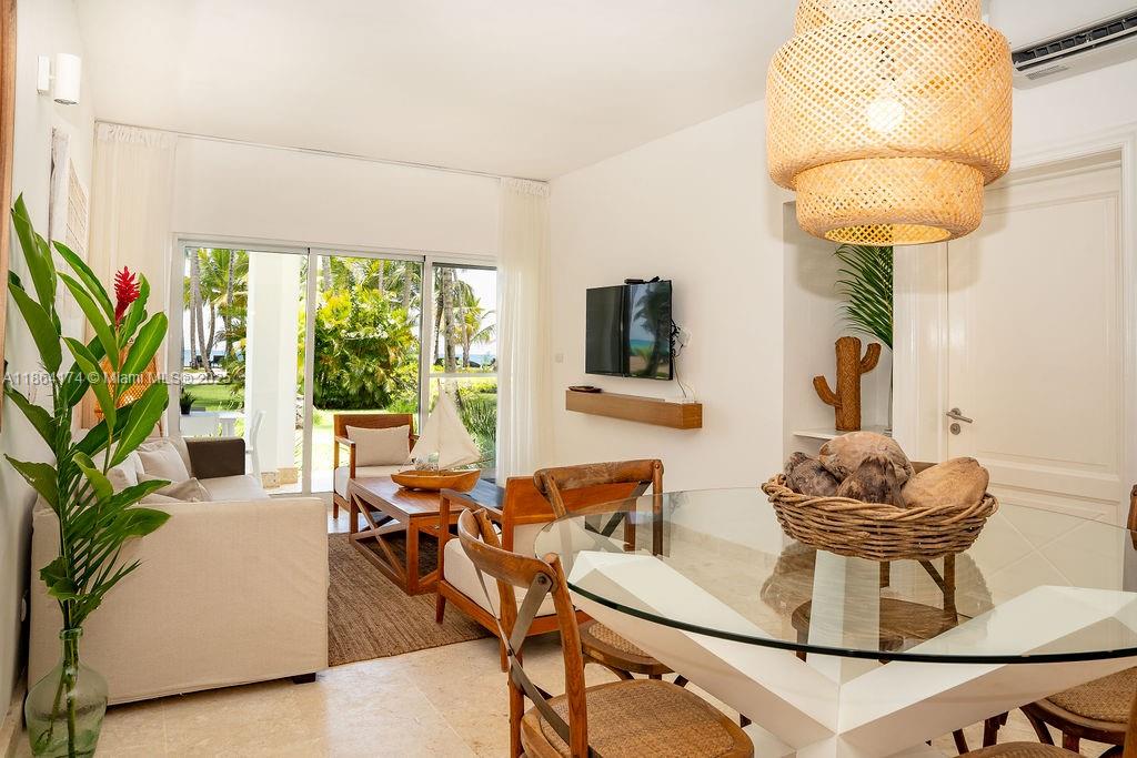 A bright living and dining area features a glass table, wicker pendant light, and patio doors — 0000 8C3F+Q62, Las Terrenas 32000, Dominican Republic # 1, DR, DR