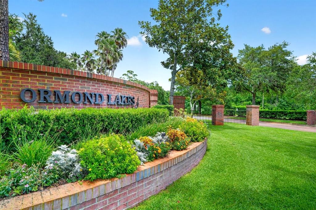A brick wall with the sign Ormond Lakes sits in front of a gated entrance — 31 WILD CAT LANE, ORMOND BEACH, FL