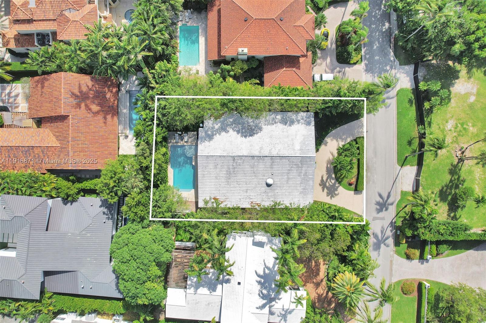 An aerial view shows a house with a pool, driveway, and surrounding trees — 145 Bal Bay Dr, Bal Harbour FL 33154, BAL HARBOUR, FL