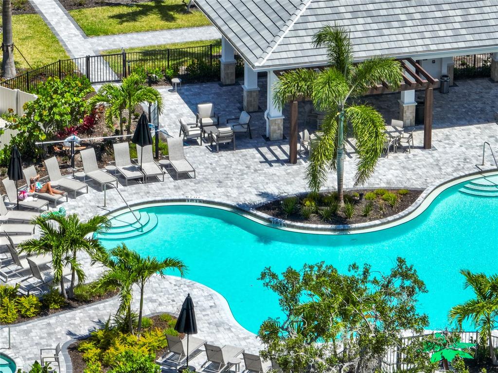 An aerial view of a swimming pool with lounge chairs and a covered patio area — 5744 HAVEN TERRACE TERRACE, NOKOMIS, FL