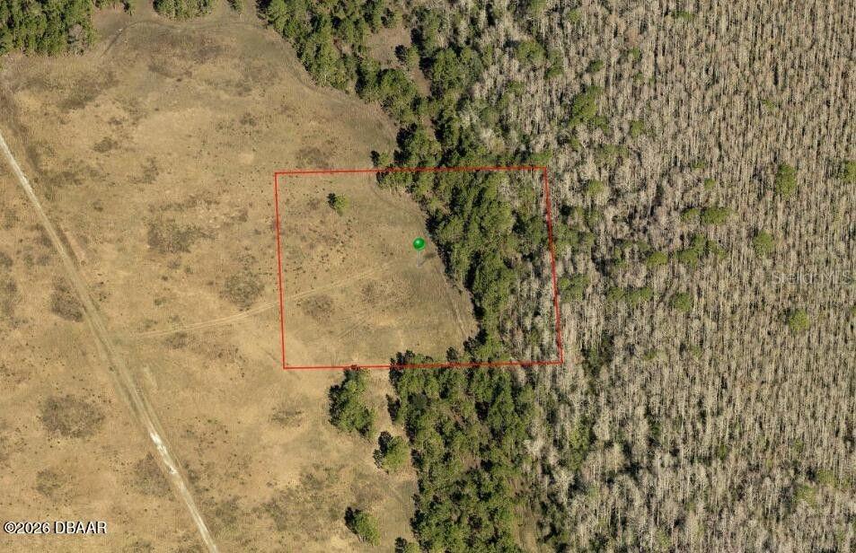 An aerial view shows a square parcel of land featuring open field and wooded areas — NO STREET NAME, DELAND, FL
