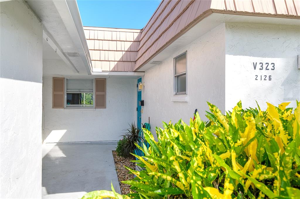 A kitchen with blue cabinets, a stone countertop, and a view of the outdoors — 2126 RIVERBLUFF PARKWAY UNIT V323, SARASOTA, FL