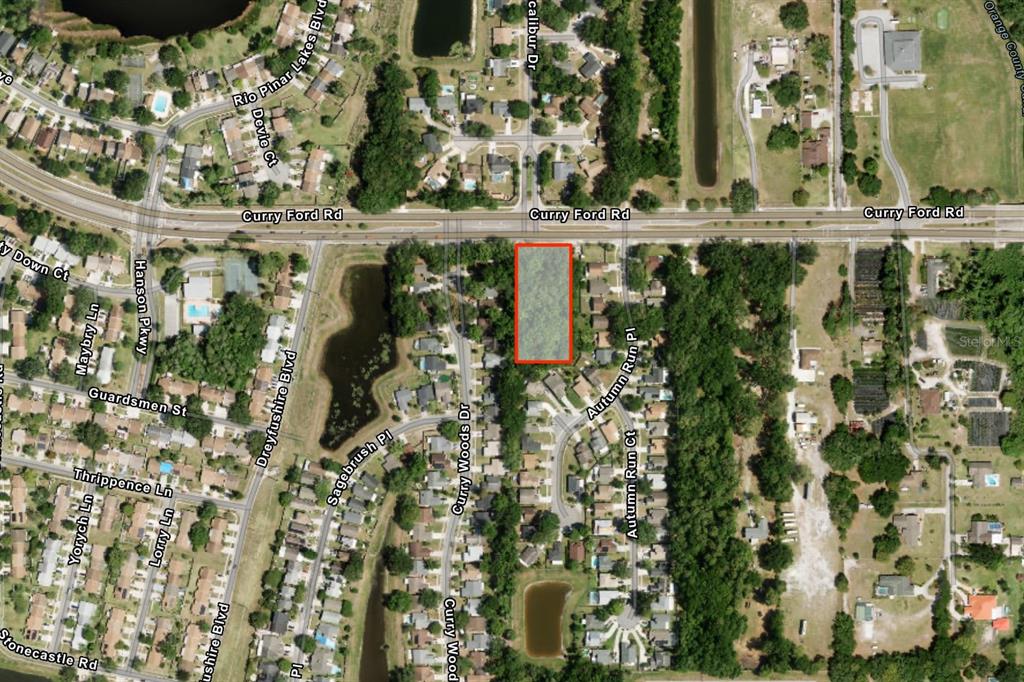 An aerial map view shows a rectangular wooded lot located south of Curry Ford Road — CURRY FORD ROAD, ORLANDO, FL