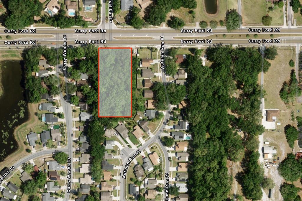 An aerial map shows a rectangular, wooded vacant lot located south of Curry Ford Road — CURRY FORD ROAD, ORLANDO, FL