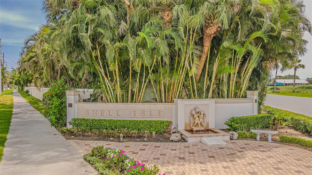 A stone monument sign reading Snell Isle stands before a dense cluster of palm trees — 243 SNELL ISLE BOULEVARD NE, ST PETERSBURG, FL