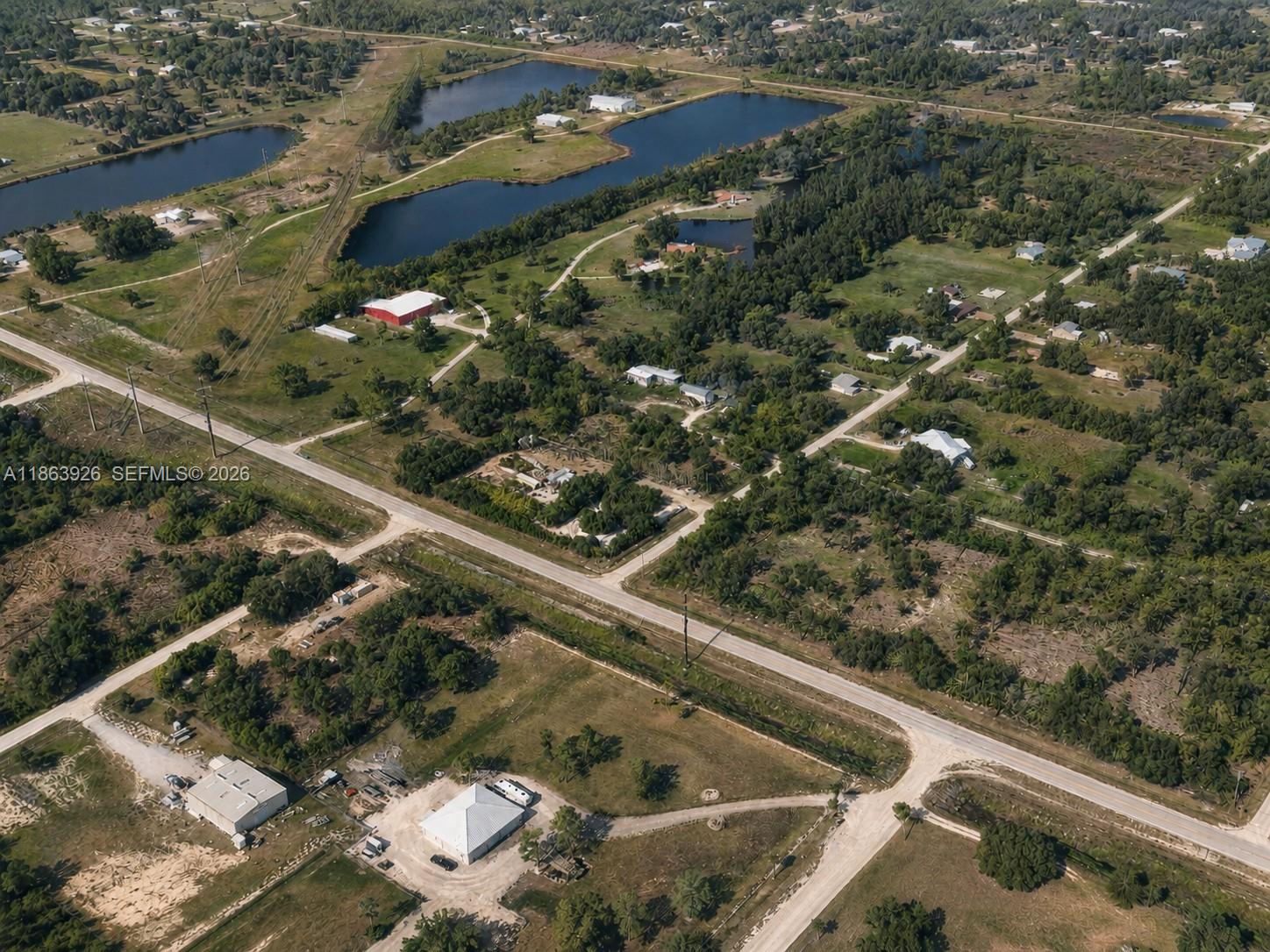 An aerial view shows rural properties with houses, outbuildings, and several ponds — 29279 Hazelwood Dr, Punta Gorda FL 33982, PUNTA GORDA, FL