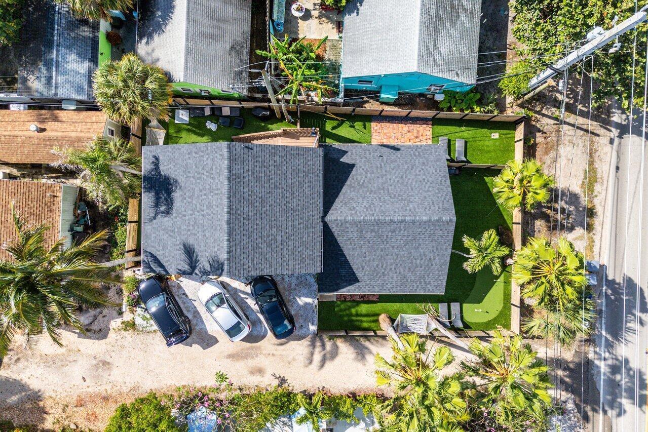 An aerial view shows a house with a gray roof, three parked cars, and landscaping — 4603 N Ocean Boulevard, Boynton Beach FL 33435, BOYNTON BEACH, FL