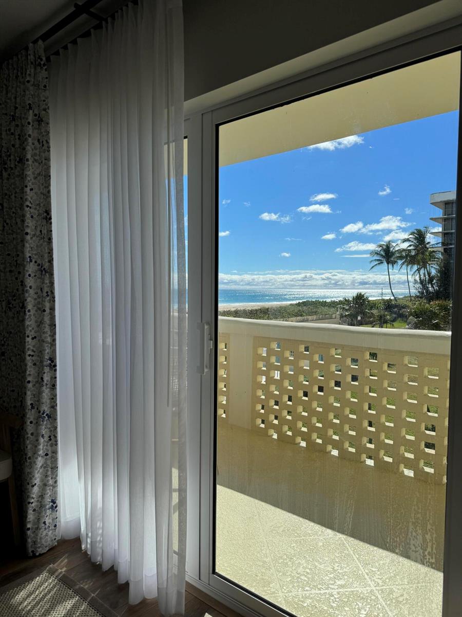 A view of the ocean and beach from a room through a glass sliding door — 2545 S Ocean Boulevard # 3140, Palm Beach FL 33480, PALM BEACH, FL