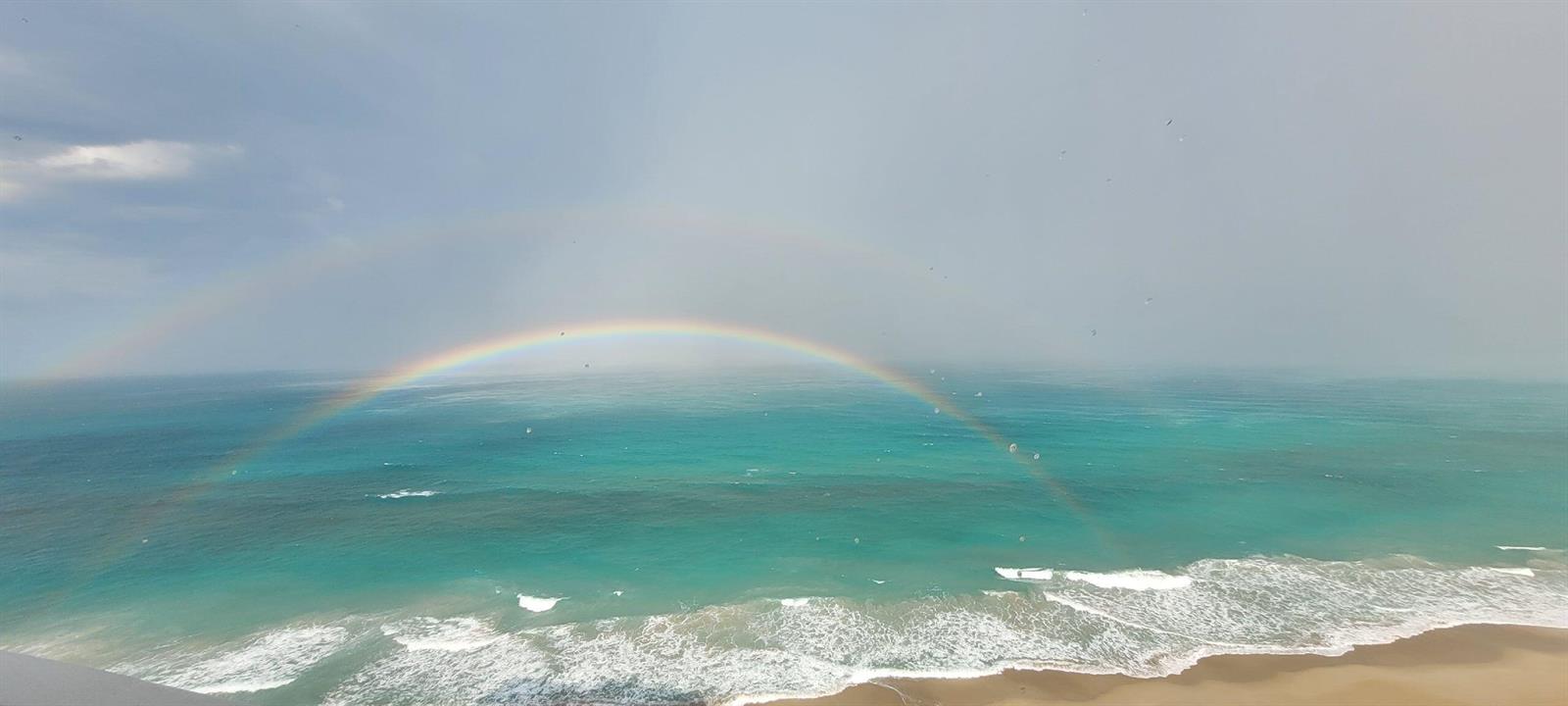 A view of the ocean and beach from a high vantage point featuring a rainbow — 9960 S Ocean Drive # 1402, Jensen Beach FL 34957, JENSEN BEACH, FL