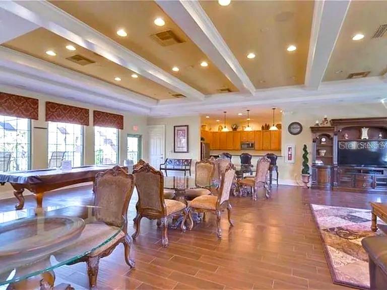 A spacious room features a pool table, dining area, and kitchen with wood cabinetry — 1169 EMERALD HILL WAY, VALRICO, FL