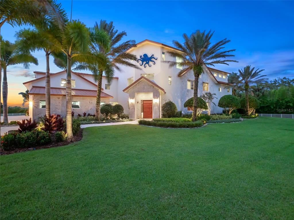 A large multi-story house with a blue octopus emblem on the exterior facade — 1511 S RIVERSIDE DRIVE, NEW SMYRNA BEACH, FL