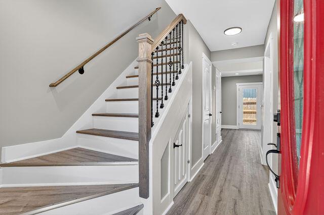 An entryway features a staircase with wood treads, a black metal railing, and gray flooring — 3241 Turner Street # 10, FL 32222, FL