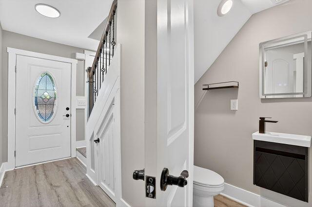 A view of a home entryway with a staircase, a front door, and a small bathroom — 3241 Turner Street # 10, FL 32222, FL
