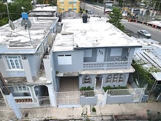 An aerial view of two adjacent two-story gray houses with flat roofs and gated entrances — 1006 JOSE GANDARA UNIT 6, SAN JUAN, PR