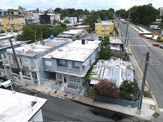 An aerial view shows a multi-unit residential building with flat roofs next to a street — 1006 JOSE GANDARA UNIT 6, SAN JUAN, PR